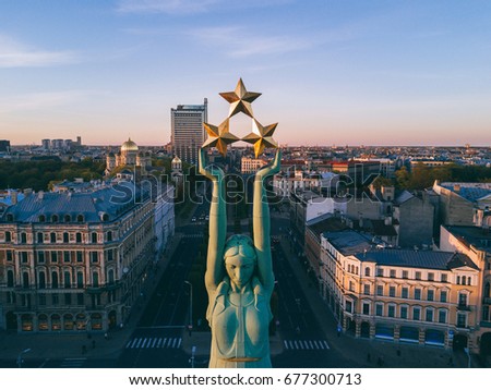 Beautiful sunset view in Riga by the statue of liberty - Milda. 