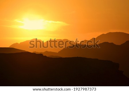 Beautiful sunset in the Wadi Rum desert. The early evening sun illuminates the mountains and valleys.