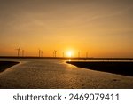 Beautiful sunset, wind turbine on the beach, Gaomei Wetland, Taichung City, Taiwan