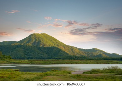 The beautiful sunshine in the morning with the reservoir of the mountain in front of the mountain and beautiful clouds in the sky.
