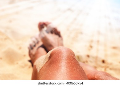 Beautiful Suntan Female Legs On Sand Beach Dark Skin Sun Rays Tropical Holiday Vacation Concept 