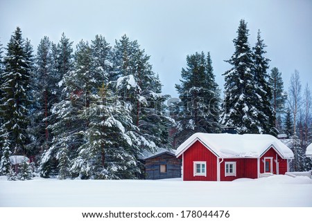 Beautiful super Finnish winter landscape with red wooden finnish house in winter covered with snow.