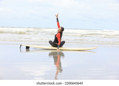 Beautiful Surfer Asian Girl On The Beach . Asian Woman Playing Surf On Sunlight.