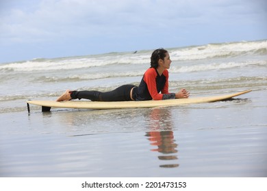 Beautiful Surfer Asian Girl On The Beach . Asian Woman Playing Surf On Sunlight.