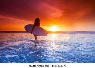 Beautiful Surfer Woman On The Beach At Sunset