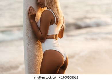 Beautiful surfer woman on the beach at sunset. Bali Indonesia. - Powered by Shutterstock