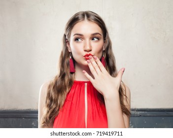 Beautiful Surprised Fashion Model Woman with Makeup Wearing Red Cloth