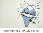 Beautiful swimsuit, sunglasses and starfish on light grey background, flat lay. Space for text