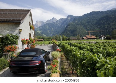 Beautiful Swiss Vineyard, Typical Village House And Luxury Black Car