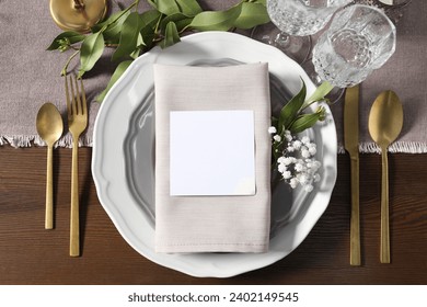 Beautiful table setting with blank card and floral decor, flat lay