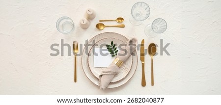 Beautiful table setting with blank card on light background 