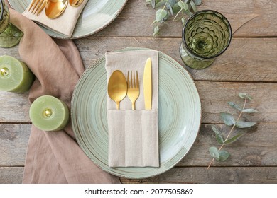 Beautiful table setting with burning candles on wooden background - Shutterstock ID 2077505869
