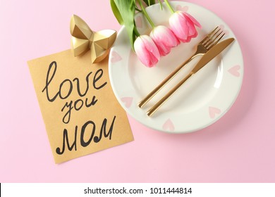 Beautiful Table Setting With Card For Mother's Day Brunch On Color Background