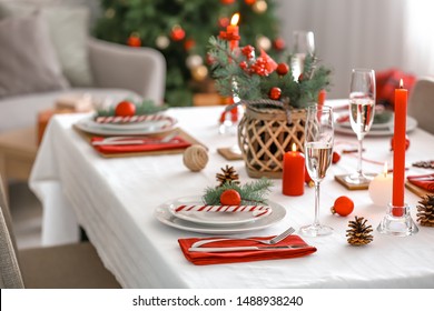 Beautiful table setting with Christmas decorations in living room - Powered by Shutterstock