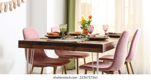 Beautiful table setting for Easter decorated with carrots in dinning room