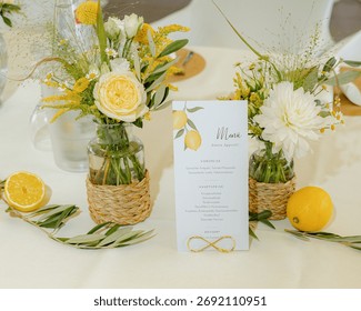 Beautiful table setting featuring vibrant floral arrangements in woven vases, complemented by a menu card adorned with lemon illustrations. Fresh lemons and greenery enhance the scene