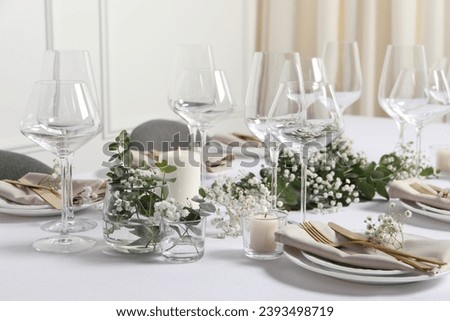 Beautiful table setting with floral decor indoors