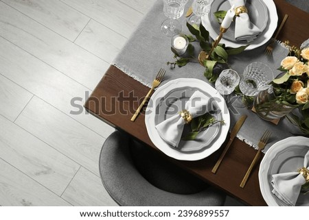 Beautiful table setting with floral decor, top view. Space for text