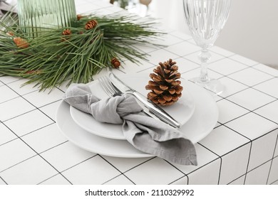Beautiful table setting with pine cone and fir branches