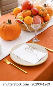 Beautiful table setting with pumpkins in dining room