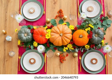 Beautiful table setting with pumpkins in dining room