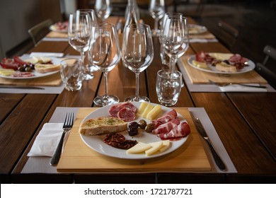 Beautiful Table Setting In A Restaurant With Glasses And Snacks. Italian Gourmet Restaurant. Cozy Interior In The Cafe. Wine Glasses. Tablescape