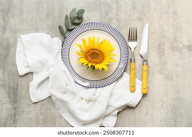 Beautiful table setting with sunflower and eucalyptus on grey background - Powered by Shutterstock