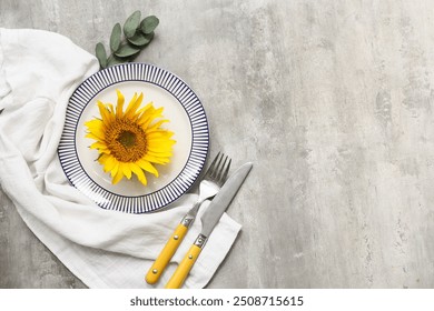 Beautiful table setting with sunflower and eucalyptus on grey background - Powered by Shutterstock