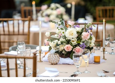 Beautiful table setting with tableware, candles, flowers, accessories and rose centerpiece for a party, wedding reception, gala banquet or other holiday event. - Powered by Shutterstock