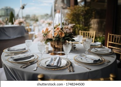 Beautiful table setting with tableware and flowers for a party, wedding reception or other holiday event. Glassware and cutlery for dinner. Beautiful Orchid protea and roses florist composition (autho - Powered by Shutterstock