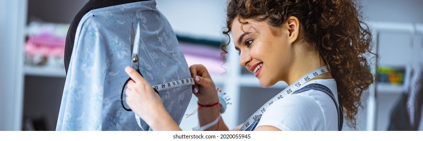 The beautiful tailor working with the dress - Shutterstock ID 2020055945