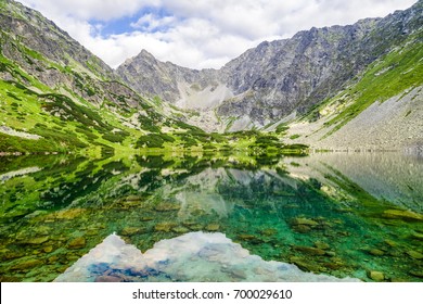 Beautiful tarn Nizne Temnosmrecinske pleso at Koprova valley in High Tatras mountains, Slovakia. Reflection in water
