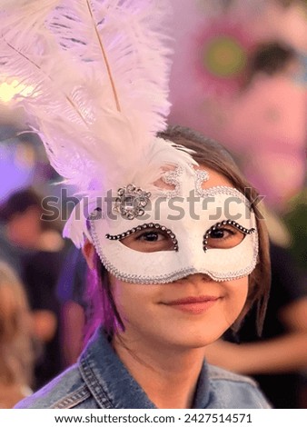 Beautiful teen age girl (female age 14) wearing a Venetian mask on carnival party.