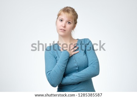 Beautiful teen girl in blue sweater over white background