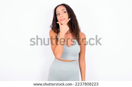 Similar – Brunette surfer woman with top and bikini holding surfboard