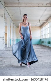 Beautiful Teen Girl Playing With Her Long, Glamorous Silver Dress. Going To Her Prom Or Dance