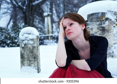 Beautiful Teen Grieving In A Cemetery.  Cooling Filter Applied For Ambiance.