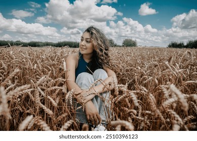 Beautiful teenage girl with long curly hair posing in a wheat field - Powered by Shutterstock