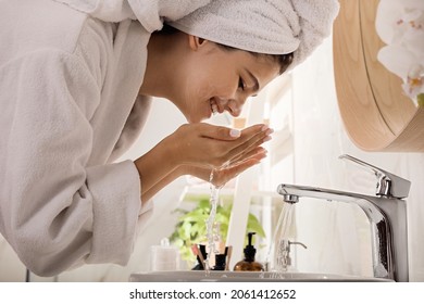 Beautiful teenage girl washing face with cleansing foam in bathroom. Skin care cosmetic - Powered by Shutterstock