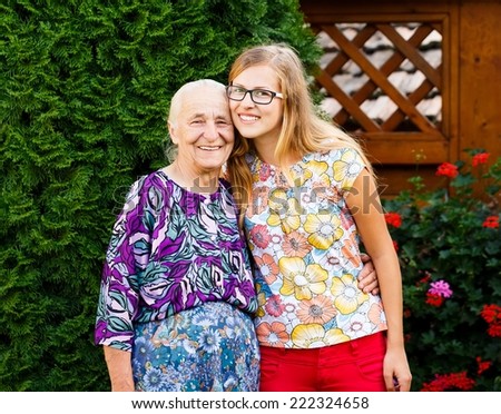 Similar – Woman taking selfie with older mother in wheelchair