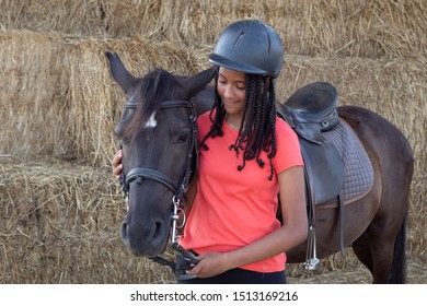 Beautiful teenager with his horse learning to ride in the riding school - Powered by Shutterstock