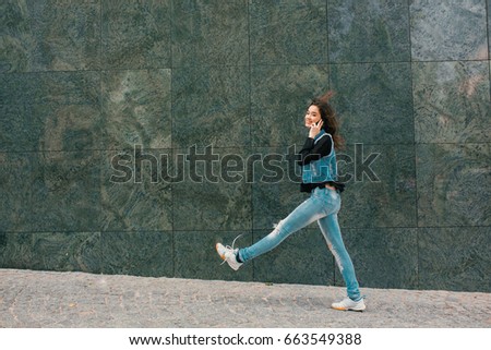 Similar – Image, Stock Photo Happy woman jumping in front of stone wall background