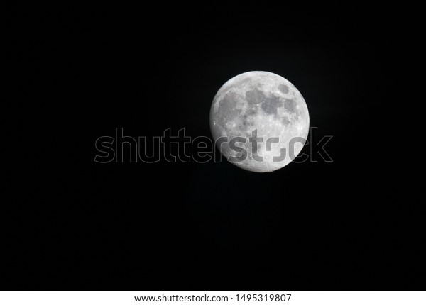 A beautiful telephoto close up view of\
full moon at night time. Star gazing into\
space.