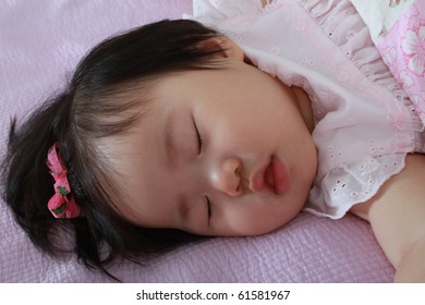 Beautiful Ten Month Old Asian Baby Infant Girl With Hairbow Sleeping Soundly