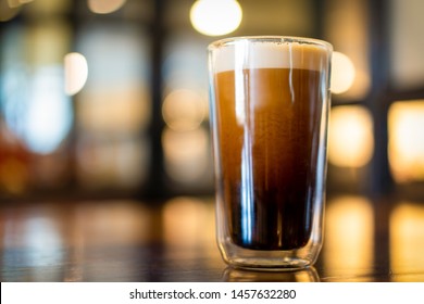 Beautiful Texture And Layers Of Nitro Cold Coffee Served In A Dubble Wall Glass Close Up.