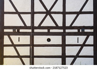 Beautiful texture of old vintage half timbered walls. Detail of an old half-timbered made of dark brown wooden beams and white plastered spaces with painted decor. background of half timbered wall