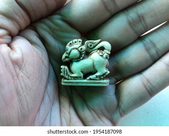 Beautiful Thai amulet close-up carved with a gouge from old ivory is Liger duck mouth(duck + Liger) on white background. Religious Buddhist amulets for protection safety for danger and good luck. 