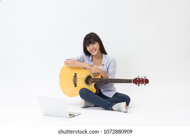 Beautiful Thai Girl Learning To Play Music Online Sitting On White Background 