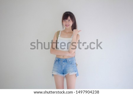 Beautiful Thai girl tourists scottish White shirt blue jeans pointing