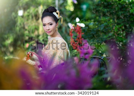 Beautiful Thai girl in Thai traditional costume,thai dress,Thai women wearing typical Thai dress, identity culture of Thailand